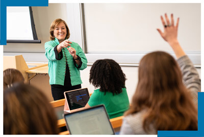 GSEHD professor points to student with hand raised in auditorium style class